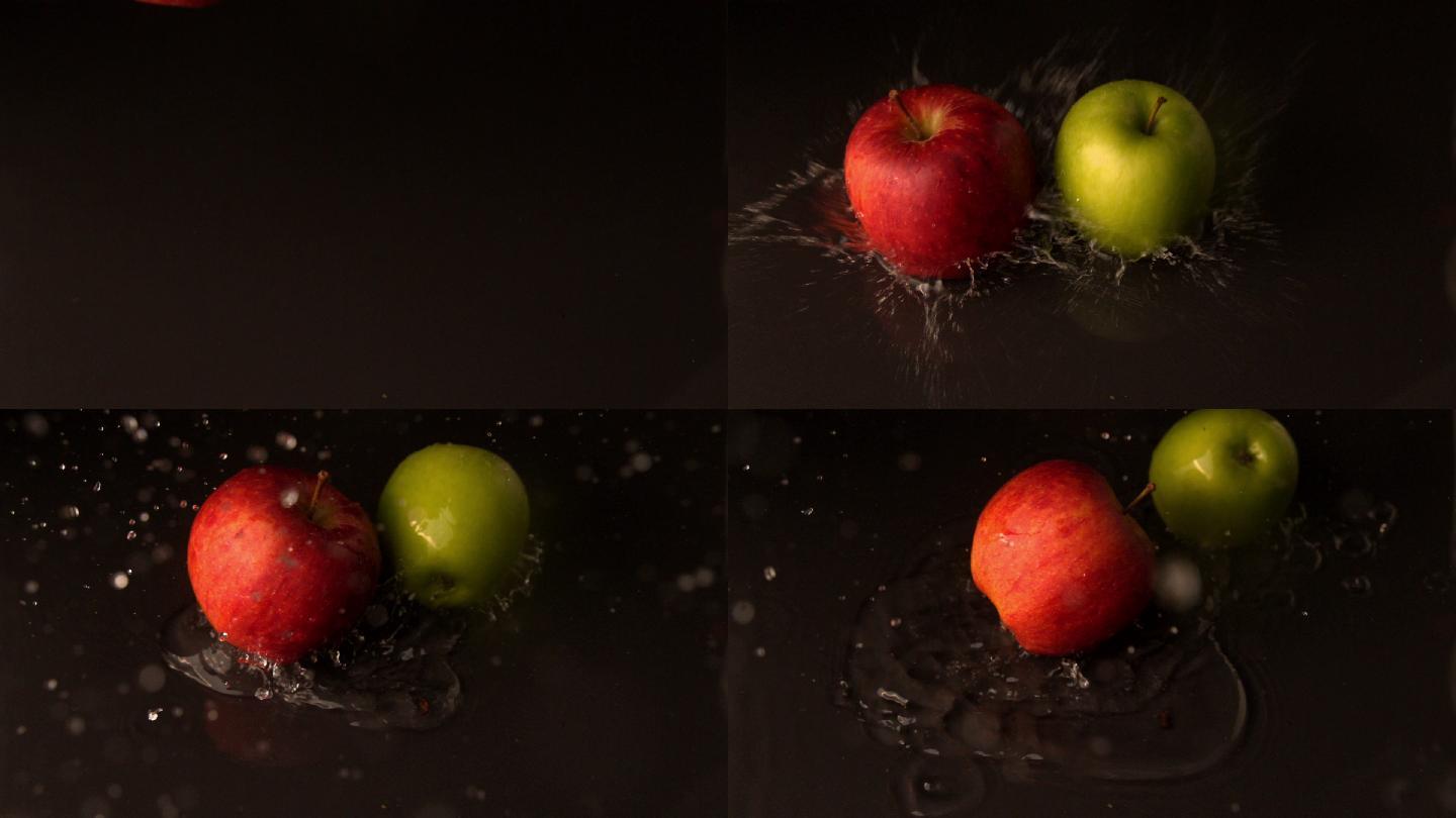 绿色和红色的苹果落在潮湿的黑色表面的慢动作