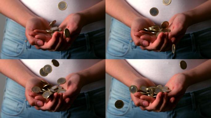 一名女子用慢镜头接住掉落的欧元硬币
