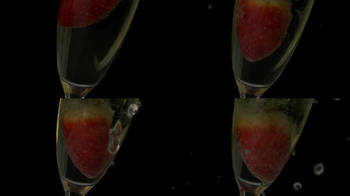 草莓落入香槟的慢动作长笛