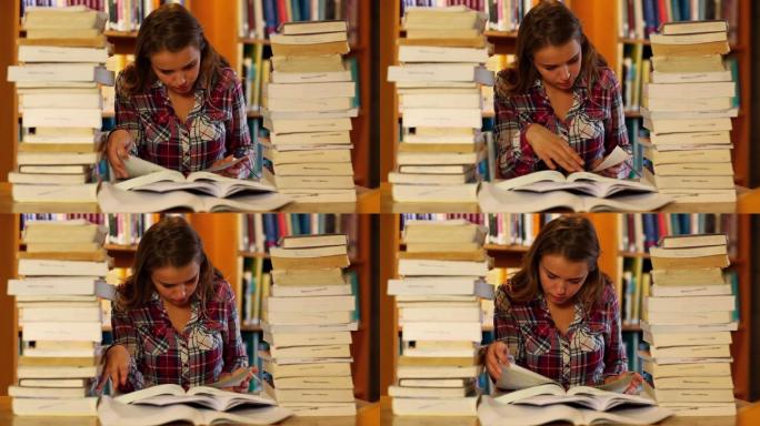 在大学里，专心学习的学生在图书馆周围的书