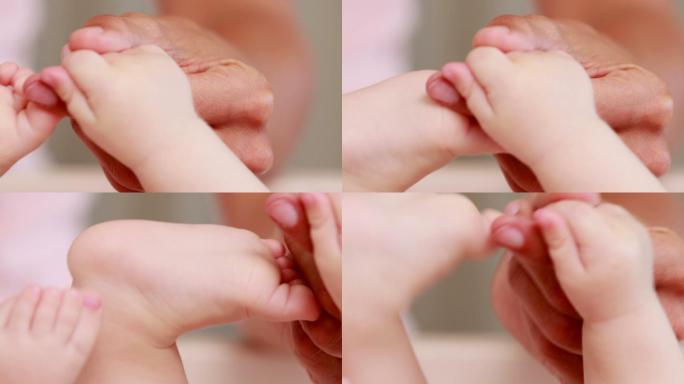 在家里用布满皱纹的手牵着婴儿的手