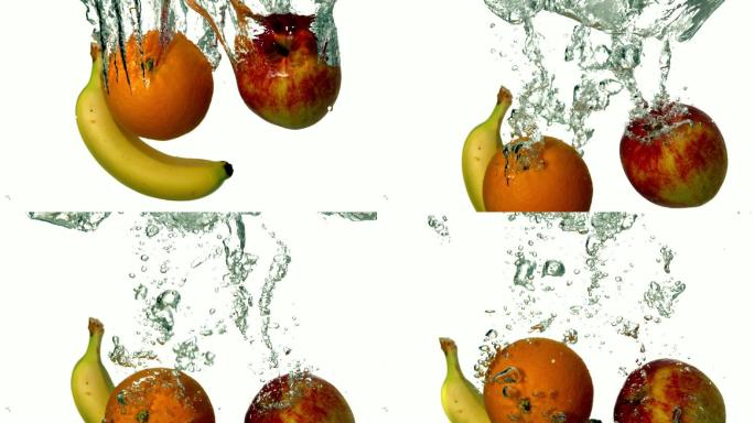 在慢镜头中，香蕉、苹果和橙子在白色背景下坠入水中