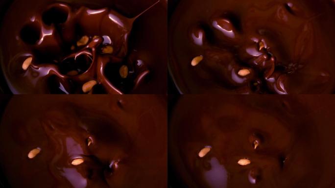 花生落在融化的巧克力里的慢镜头