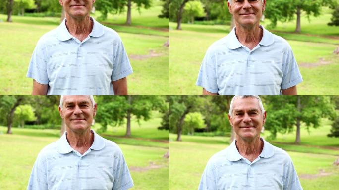 Retired man in the park smiling at camera on a sun