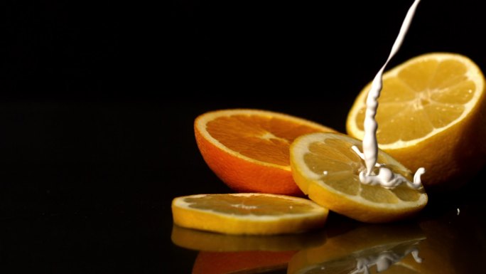 用慢镜头将鲜奶油倒在橙子片上
