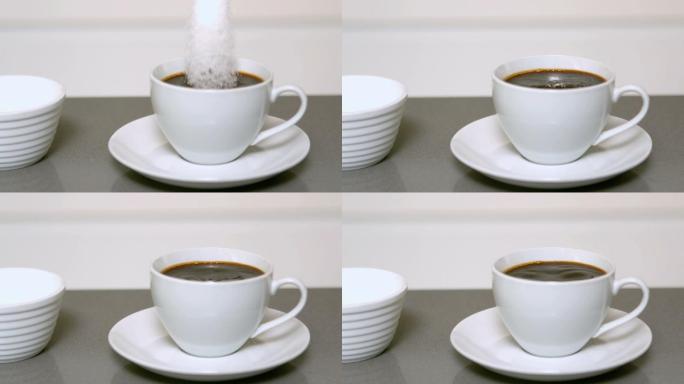 慢动作将糖倒入一杯咖啡中