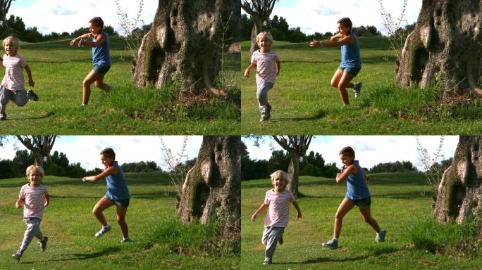 小女孩绕着树追小男孩的慢镜头