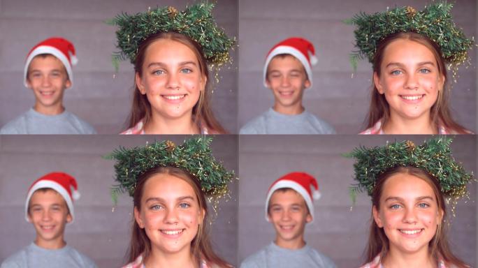 兄妹戴着圣诞帽和花环微笑特写