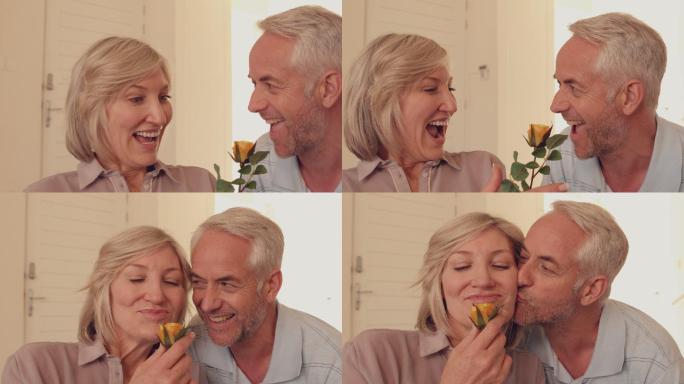 一个男人在慢镜头中给他的妻子一朵黄玫瑰