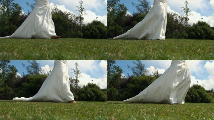 穿着婚纱的新娘在草地上慢镜头行走