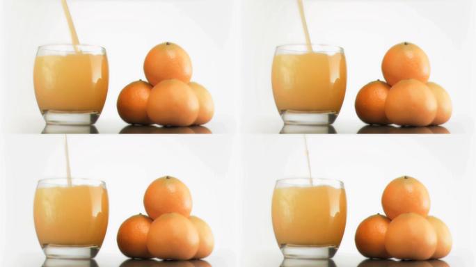 橙子和倒橙汁特写榨汁流体果饮