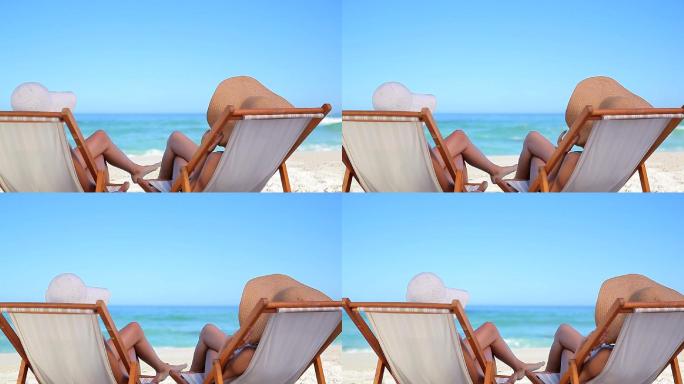 女人们躺在沙滩椅上休息特写