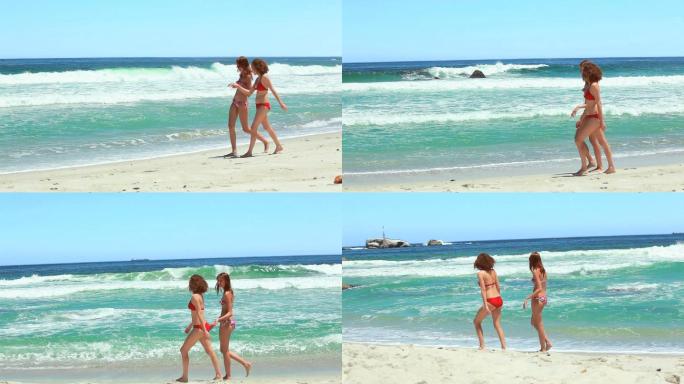 两个女人在海滩上边走边聊天