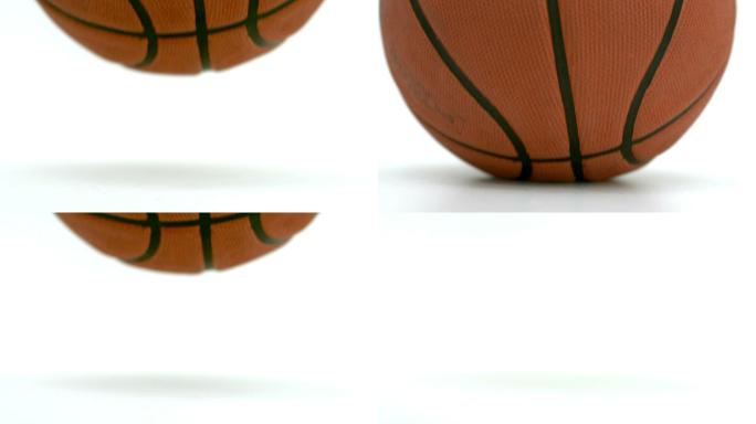 一个篮球在白色背景下坠落的近距离观察