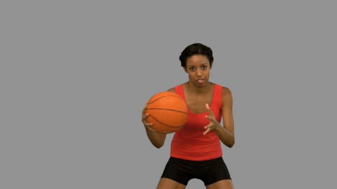 女人在灰色背景下打篮球特写