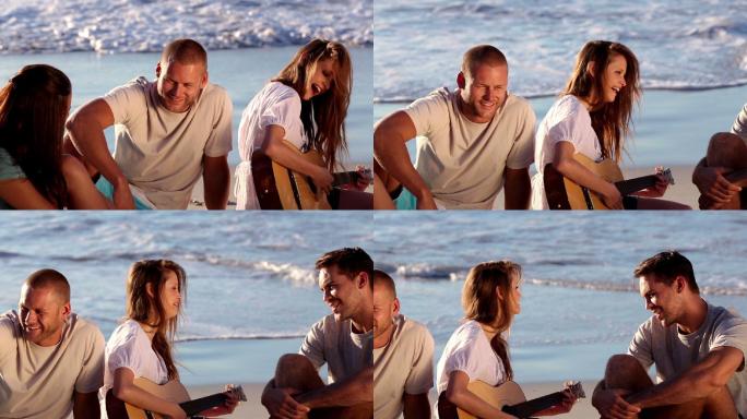 一群朋友在海滩上弹吉他