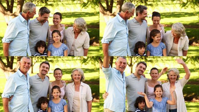在一个阳光明媚的日子里，快乐的大家庭对着镜头微笑