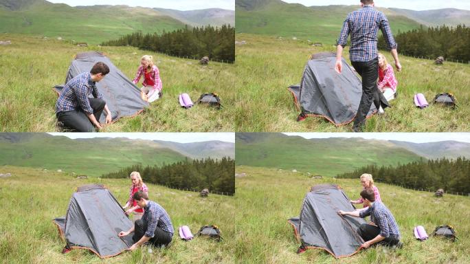 一对夫妇在户外搭帐篷野营特写