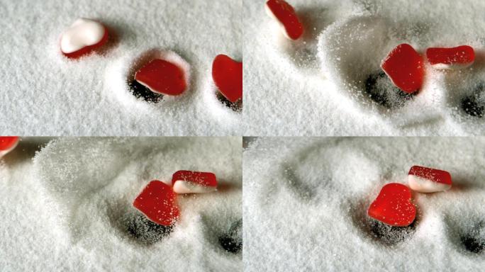 心形糖果在慢镜头中掉落在一堆糖中