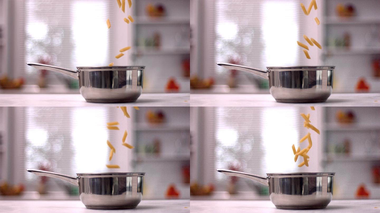 通心粉在慢镜头中掉进厨房的锅里