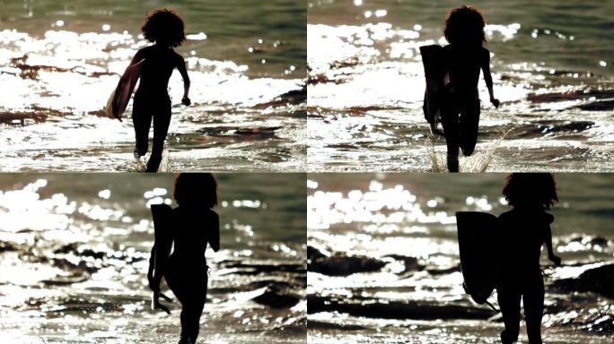 女人拿着冲浪板从海里走出来剪影特写