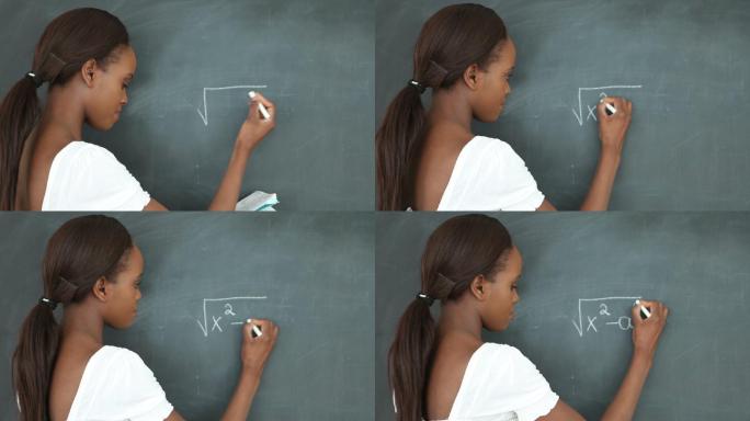 一个学生在教室的黑板上写数学题特写