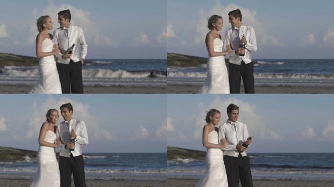 快乐的新婚夫妇在海滩上砰砰作响