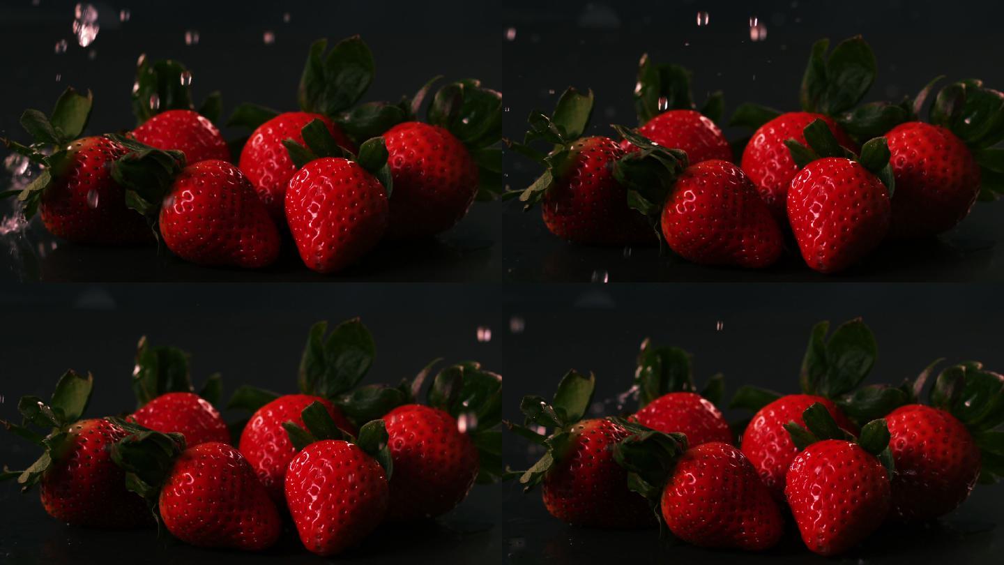 水滴在草莓的黑色表面慢动作