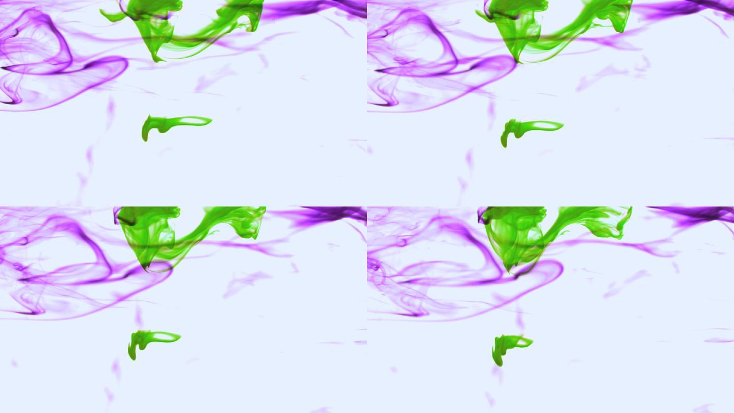 紫色和绿色的墨水在水中慢动作旋转