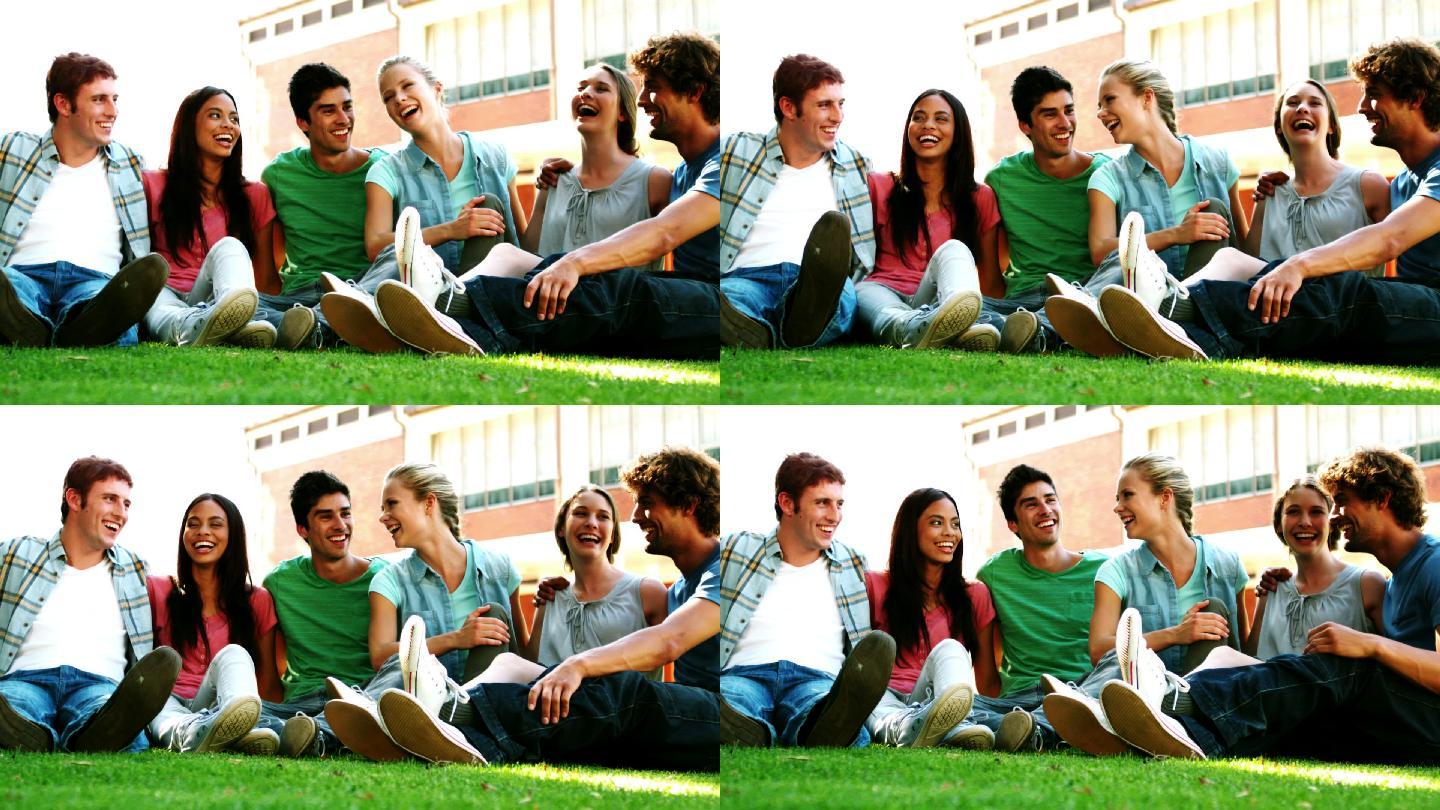 快乐的学生们一起在草地上慢镜头聊天
