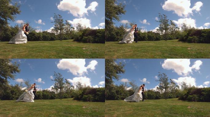 一对快乐的新婚夫妇在公园里跑步的慢镜头