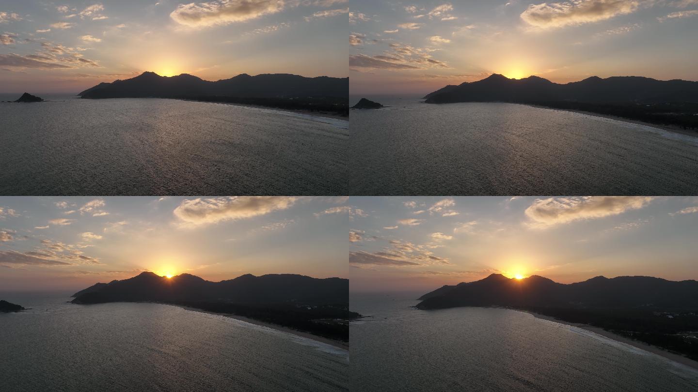 深圳西涌旅游度假区航拍海边山的背后是夕阳