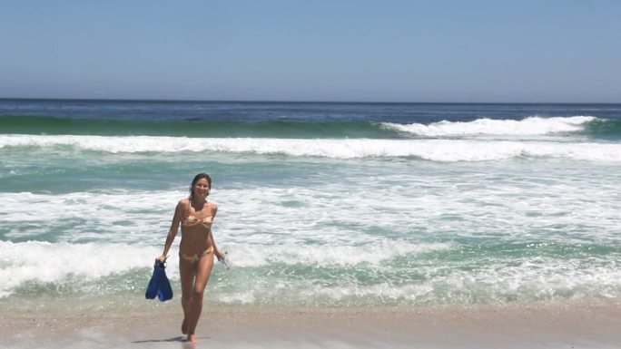 一个女人在海滩上行走的视频