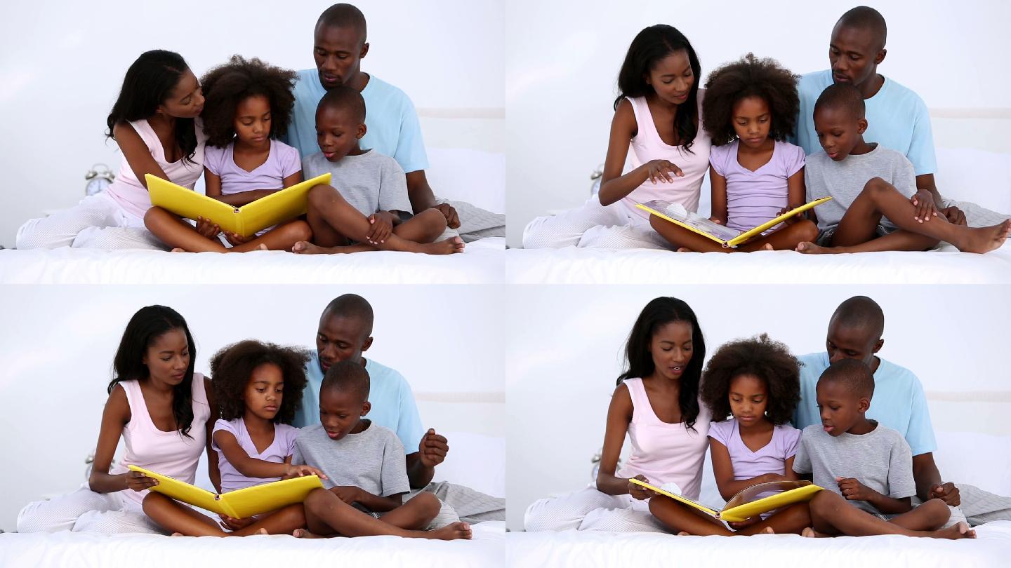 一家人在家里的床上读一本黄色的书