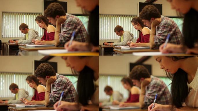 在一所大学里，学生们在教室里集中注意力进行考试