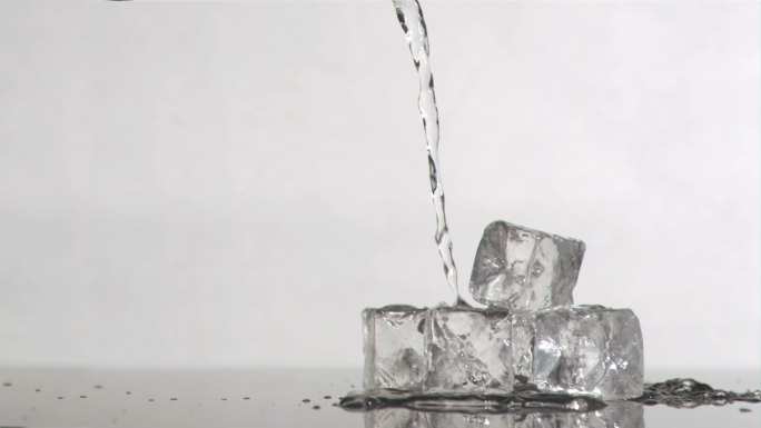 水打在冰块上特写：水打在冰块上