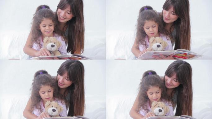 妈妈和女儿在床上读故事书