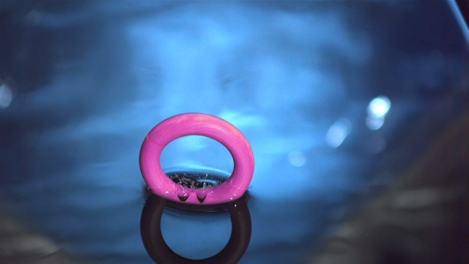 粉红色的木环落入水中特写