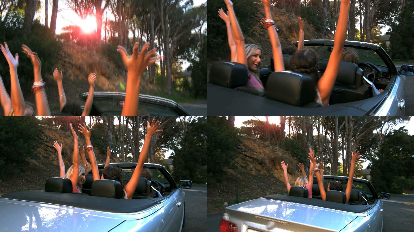 当人们在慢镜头中开车时，快乐的朋友们举起了手