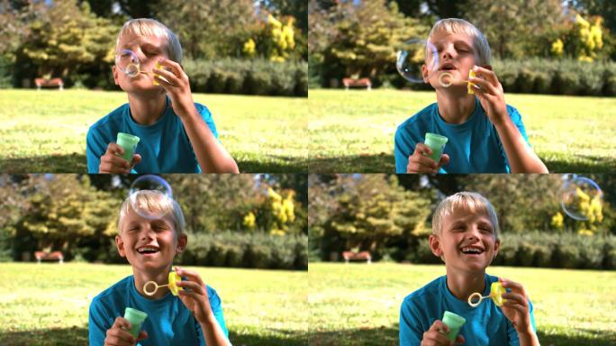 男孩在公园里玩吹泡泡特写