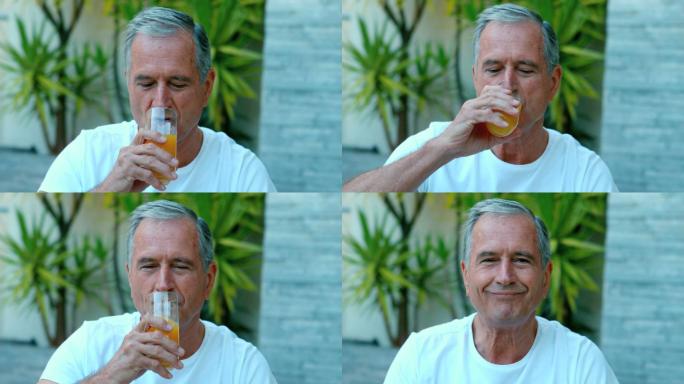 一个退休男子在外面慢镜头喝橙汁