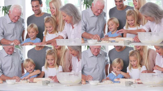 快乐的孩子们在家人的注视下享受烘焙的乐趣