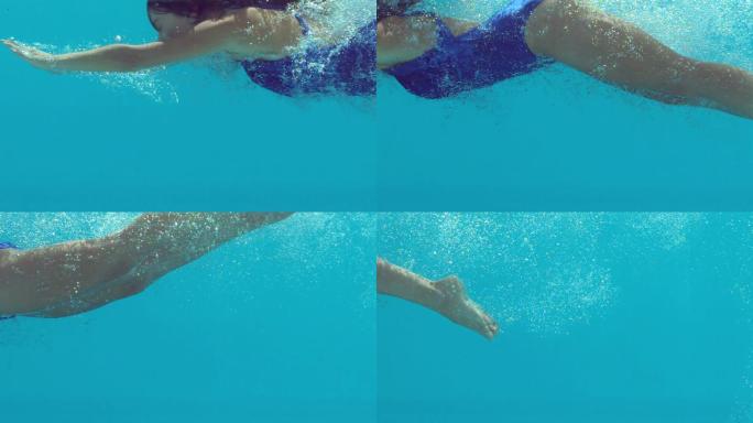 穿着蓝色游泳衣的女人在水下慢动作游泳