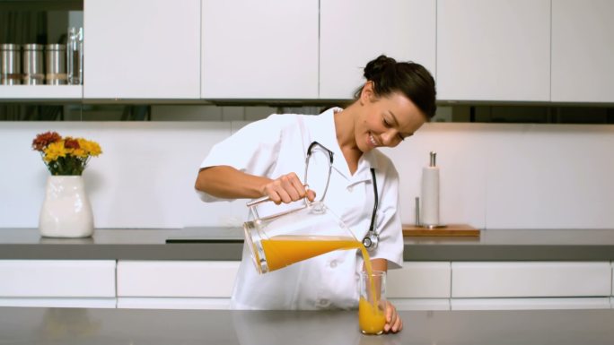 家庭护士在厨房倒橙汁的慢镜头