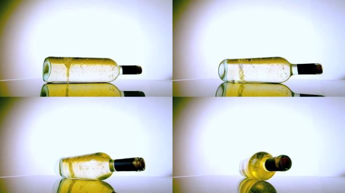 白色的酒瓶在白色的表面上以慢镜头旋转
