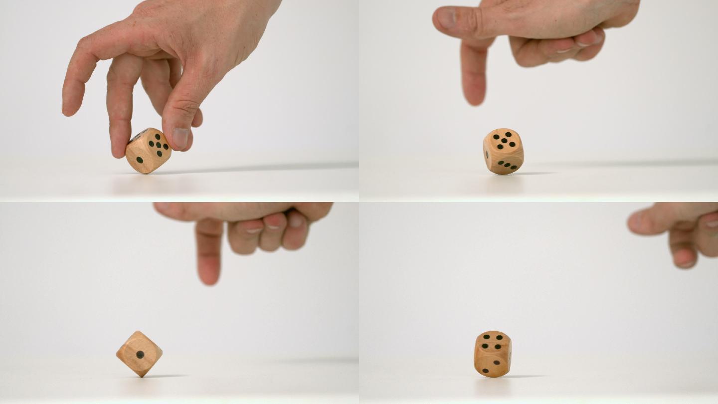 手扭转一个木制骰子特写