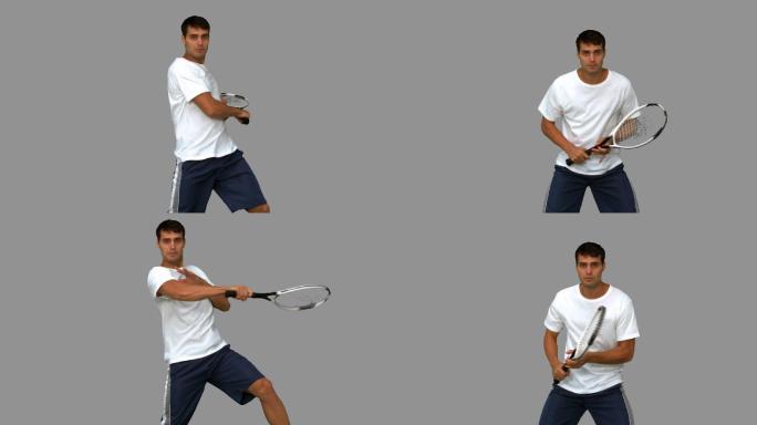 男人在灰色背景下练习打网球特写