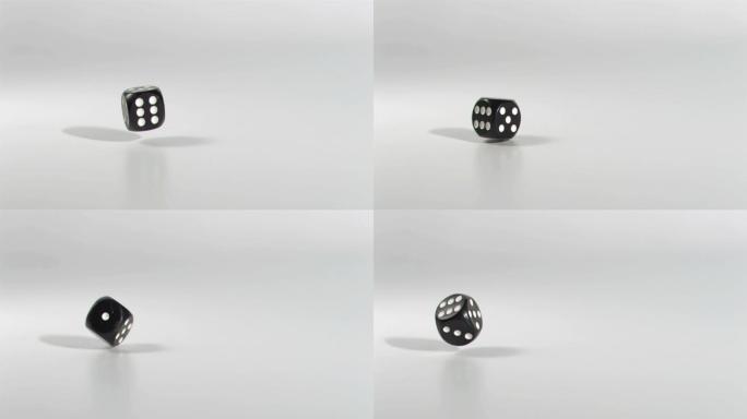 一颗黑色的骰子掉落转动特写
