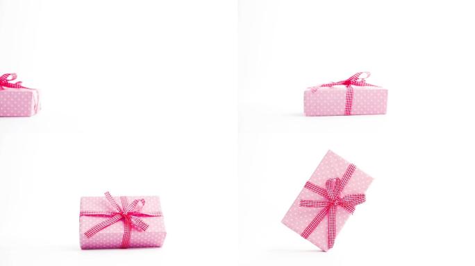 粉红色的礼物包装的礼物出现在屏幕上，并在停止运动与复制空间转动