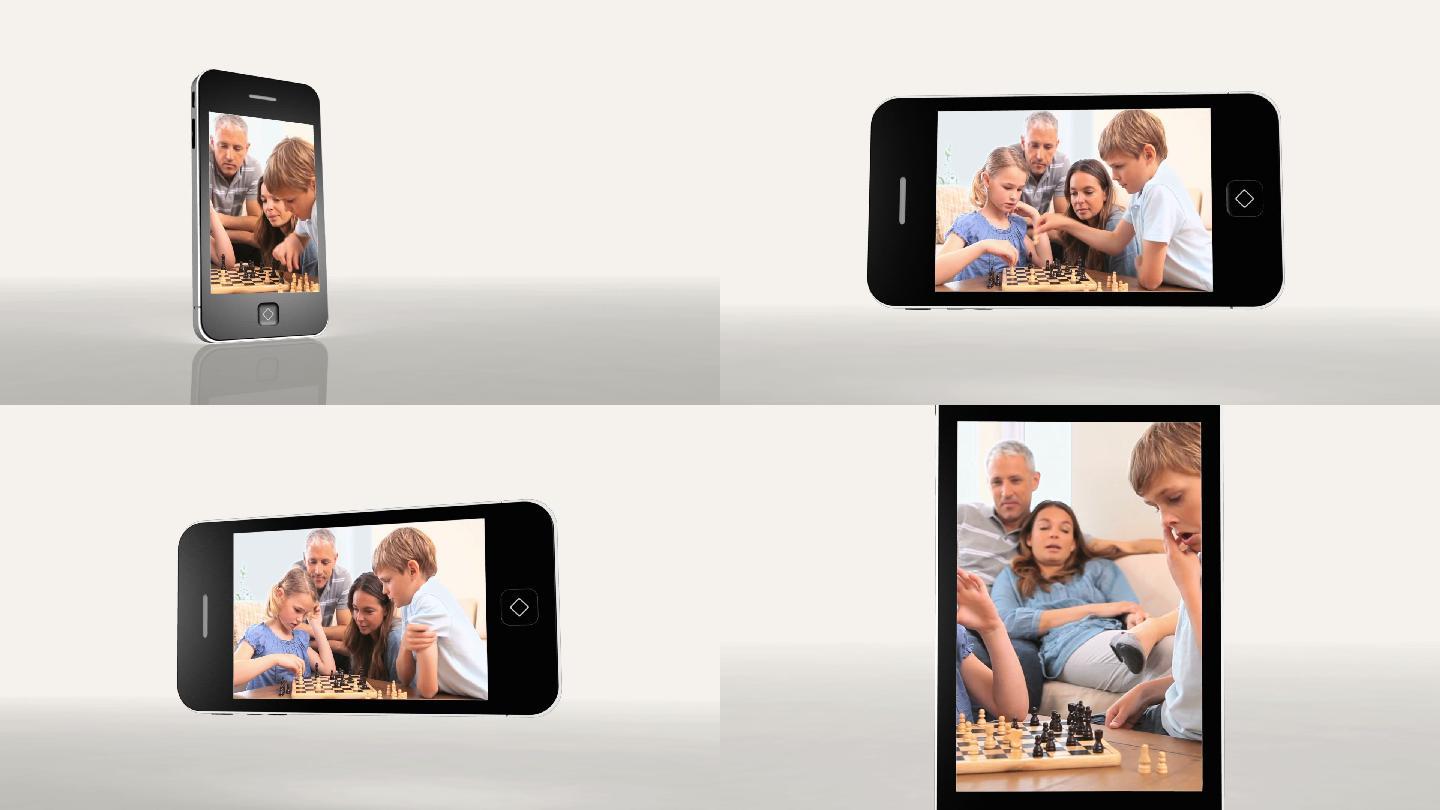 一个家庭在智能手机上下棋的视频动画